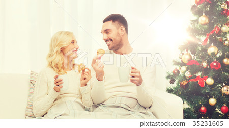 happy couple at home with christmas tree happy couple at home with christmas tree 35231605