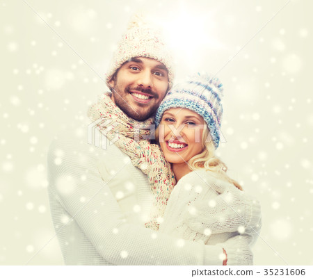 smiling couple in winter clothes hugging smiling couple in winter clothes hugging 35231606