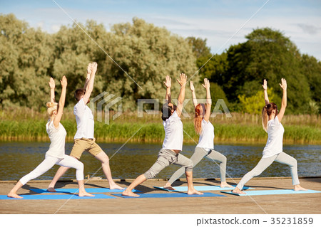 group of people making yoga exercises outdoors group of people making yoga exercises outdoors 35231859