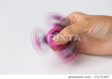 close up of hand playing with fidget spinner 35231967