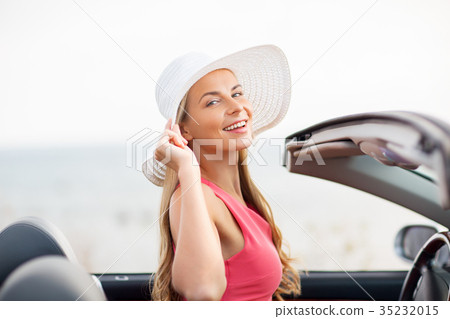 happy young woman in convertible car 35232015