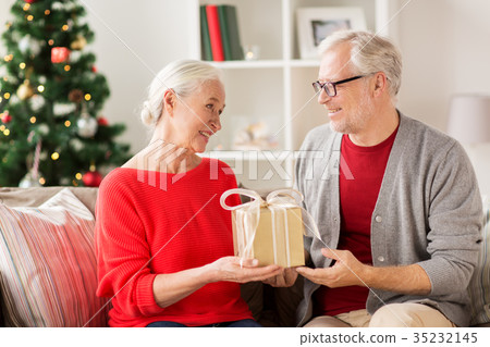 happy smiling senior couple with christmas gift happy smiling senior couple with christmas gift 35232145