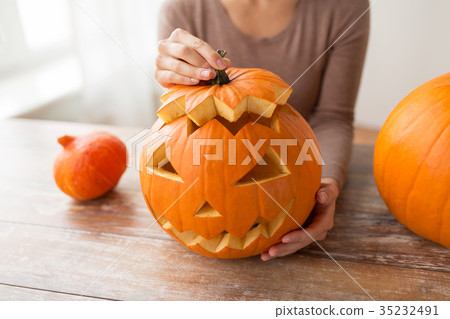 close up of woman with halloween pumpkin at home close up of woman with halloween pumpkin at home 35232491