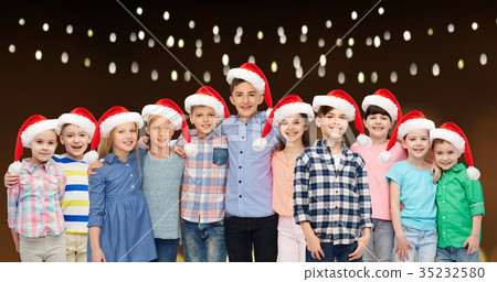 happy smiling children in christmas santa hats happy smiling children in christmas santa hats 35232580
