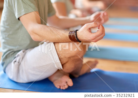 group of people making yoga exercises at studio 35232921
