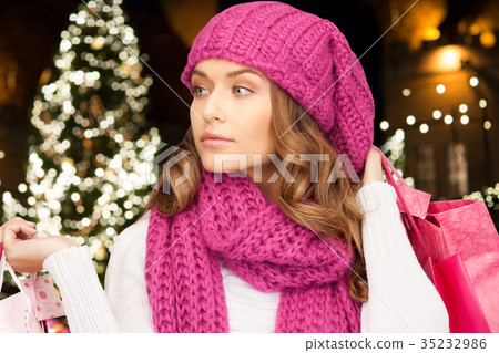 happy woman with shopping bags over christmas tree 35232986