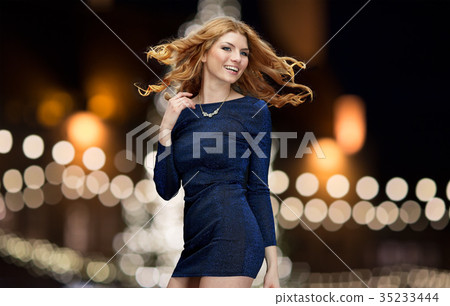 happy woman dancing over christmas tree lights happy woman dancing over christmas tree lights 35233444