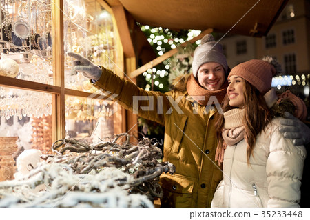 happy couple at christmas market shop window happy couple at christmas market shop window 35233448