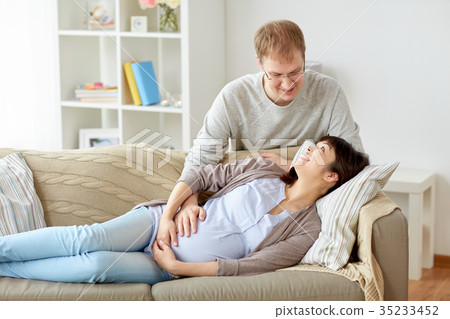 happy pregnant wife with husband at home happy pregnant wife with husband at home 35233452