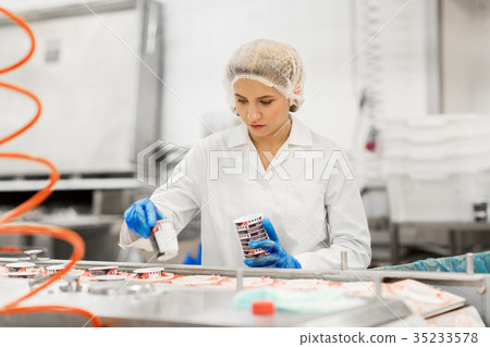 woman working at ice cream factory conveyor 35233578