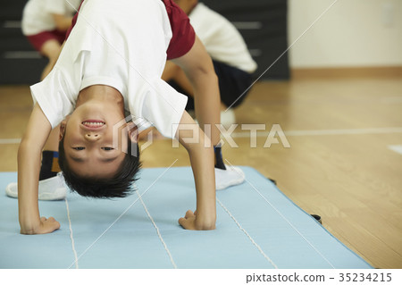 Kids doing exercise on mats 35234215