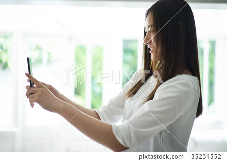 A woman to take with a smartphone A woman to take with a smartphone 35234552