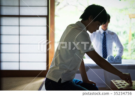 Boy pointing at shogi 35234756