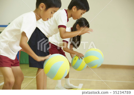 Gymnastics class Children practicing putting on a ball Gymnastics class Children practicing putting on a ball 35234789