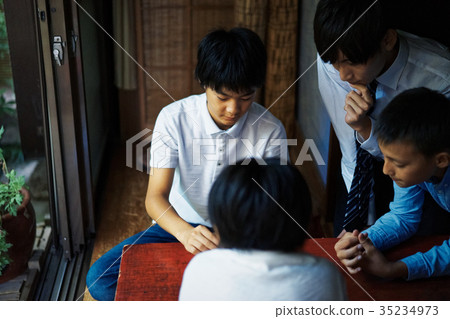 A boy studying Shogi 35234973