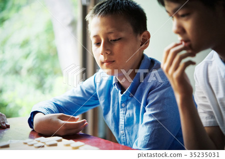 A boy studying Shogi 35235031
