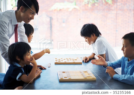 A boy studying Shogi 35235166