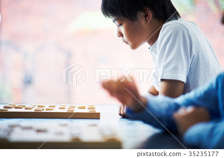 Boy pointing at shogi Boy pointing at shogi 35235177