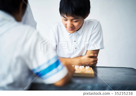 A boy studying Shogi 35235238