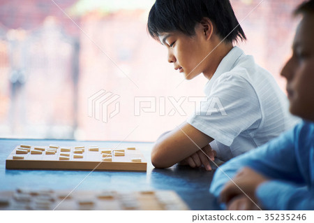 Boy pointing at shogi 35235246
