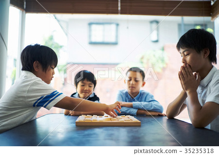 Boy pointing at shogi Boy pointing at shogi 35235318