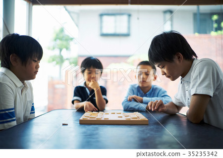 Boy pointing at shogi Boy pointing at shogi 35235342