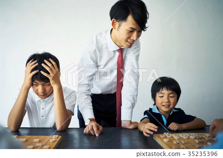 Men teaching shogi to children Men teaching shogi to children 35235396