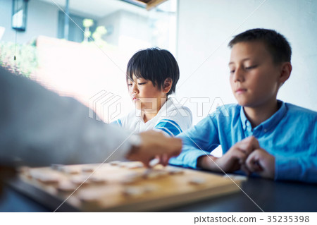 A boy studying Shogi 35235398