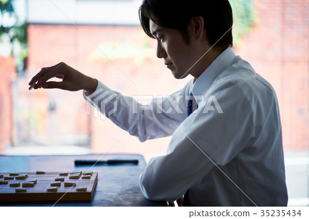 Men pointing to Shogi 35235434