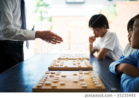 A boy studying Shogi 35235493