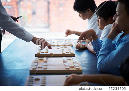 A boy studying Shogi A boy studying Shogi 35235503