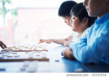 A boy studying Shogi A boy studying Shogi 35235558