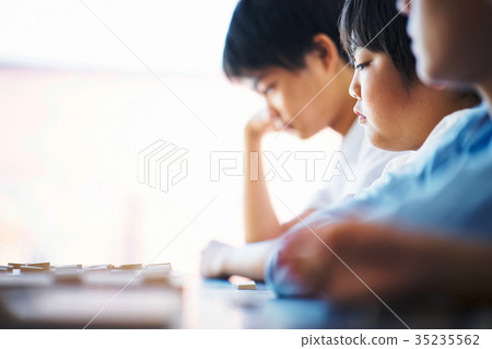 A boy studying Shogi A boy studying Shogi 35235562