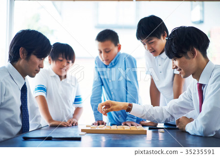 A boy studying Shogi 35235591