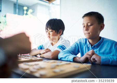 A boy studying Shogi 35235639