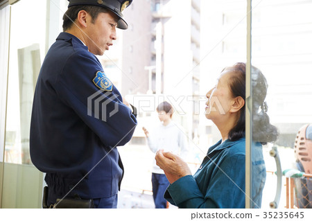 Senior lady speaking at police box 35235645