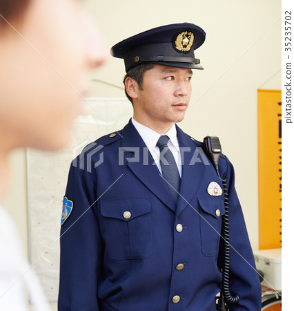 Policeman standing in front of the police box 35235702