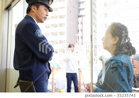 Senior lady speaking at police box Senior lady speaking at police box 35235743