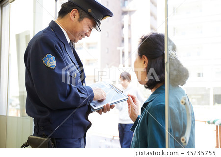 Senior lady speaking at police box 35235755