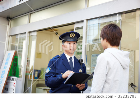 Men speaking in a police box 35235795