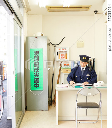 Policeman working at a police box 35235914