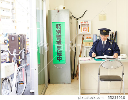 Policeman working at a police box 35235918
