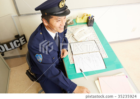 Policeman working at a police box Policeman working at a police box 35235924