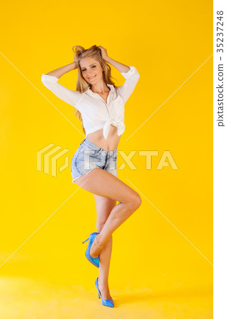 skinny girl posing on a yellow background fashion 35237248
