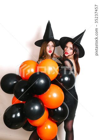 Two happy sexy women in black witch halloween Two happy sexy women in black witch halloween 35237457