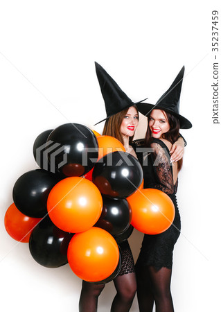 Two happy sexy women in black witch halloween 35237459