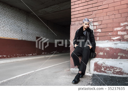 Young beautiful fashion girl shooting outdoors Young beautiful fashion girl shooting outdoors 35237635