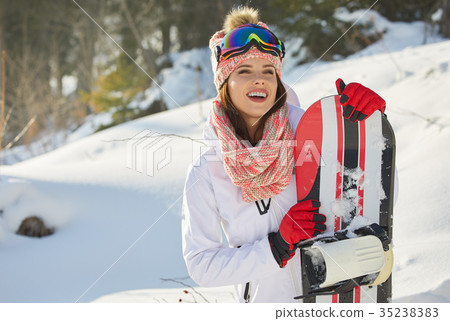 Sexy snowboarder woman outdoors. Winter resort Sexy snowboarder woman outdoors. Winter resort 35238383