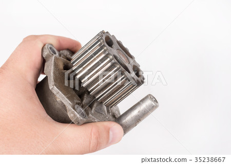 Old car water pump in the hand on white background 35238667