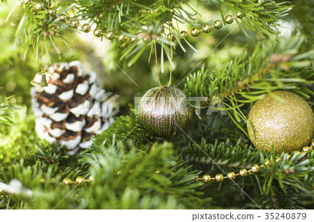 Gold decoration toys and cone on the fir-tree 35240879
